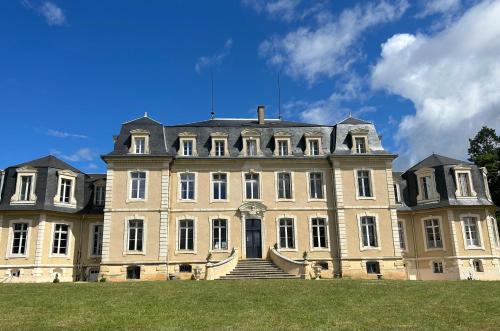 a large building with a staircase in front of it at Gîte du campagnard du château de la Bouchatte in Chazemais