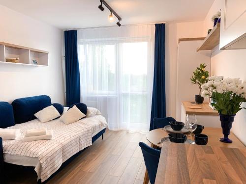 a living room with a couch and a table at Healthy Life Apartment in Warsaw