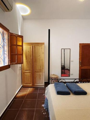 a bedroom with two beds and wooden cabinets at Cozy apt ‘Lemuna’ second line Assala beach in Dahab