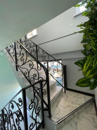 a staircase with a glass and metal railing at Royal Ak-Terek Issyk-kul in Ak-Terek