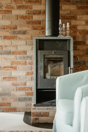 a brick wall with a fireplace in a living room at Rynke gård in Ljungbyhed