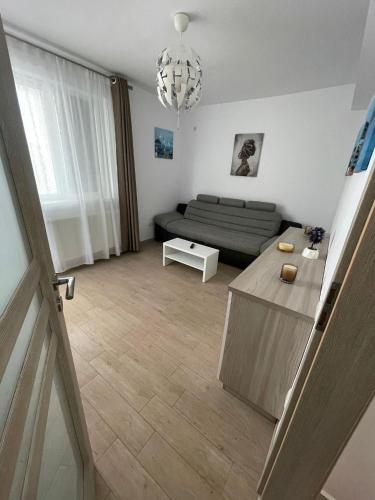 a living room with a couch and a table at HOME NAS Bragadiru in Bragadiru