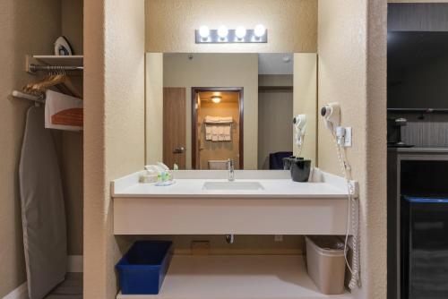 a bathroom with a sink and a large mirror at Quality Inn & Suites in Grimsby