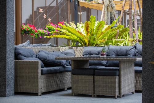 a table and chairs with plants on a patio at Sabai Sabana in Pattaya Central