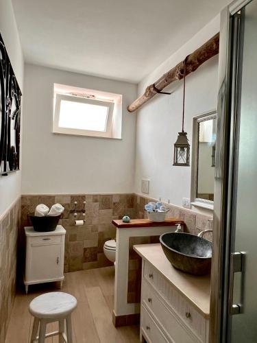 a bathroom with a sink and a toilet at Cerio Guest House in Anacapri