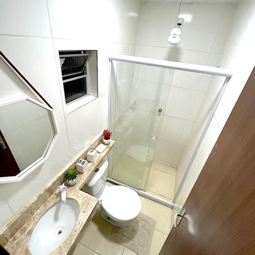 a bathroom with a shower and a toilet and a sink at Apartamento Próximo do Aeroporto in Lauro de Freitas