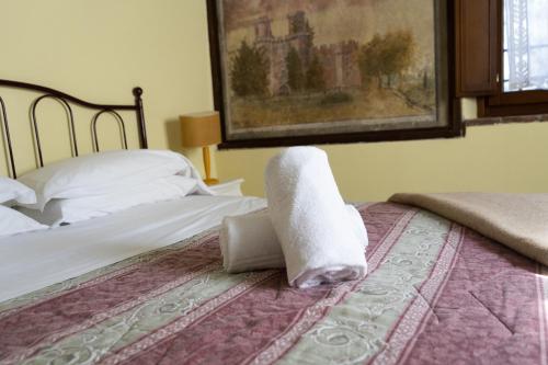 Postel nebo postele na pokoji v ubytování Borgo Giusto Tuscany