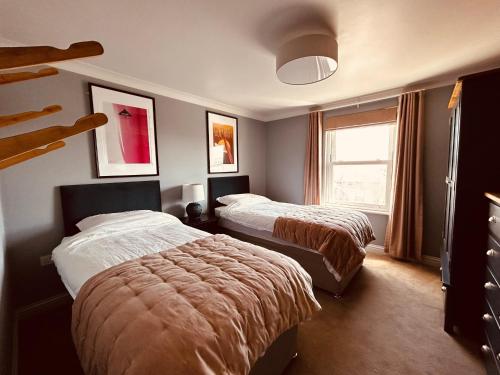 a hotel room with two beds and a window at Pentire Headland Retreat in Newquay