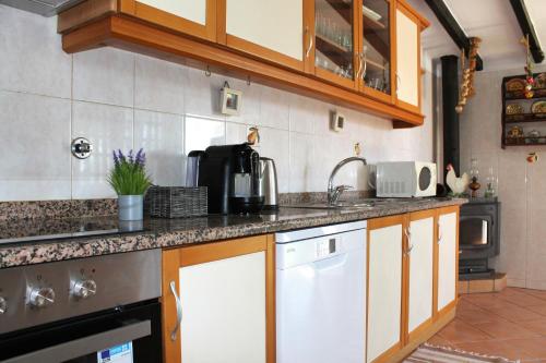 a kitchen with a sink and a counter top at Casa do Limoeiro in Albufeira
