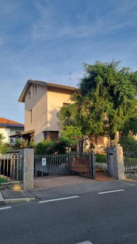 a house with a fence in front of a street at Orio Welcome in Grassobbio