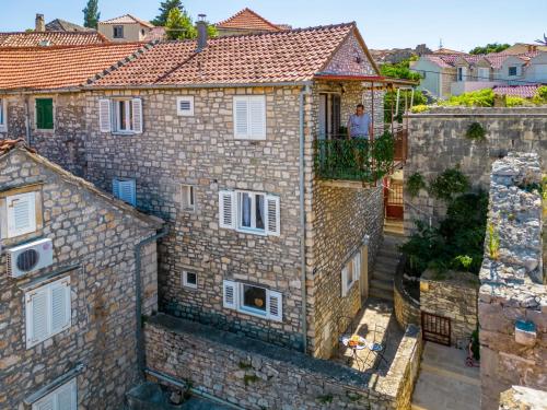 an aerial view of a stone building with white windows at Apartmani P&S in Supetar