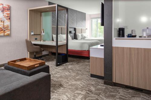 a hotel room with a bed and a bathroom at SpringHill Suites Atlanta Alpharetta/Roswell in Roswell