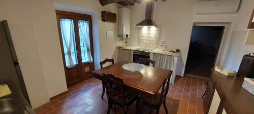 a kitchen with a wooden table and a dining room at La Casina in Fornello