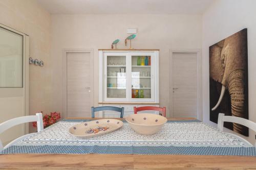 a dining room with a table with an elephant on the wall at Villa Althea by BarbarHouse in San Pietro in Bevagna