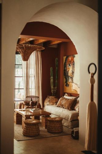 a living room with a couch and a table at The Lund Tulum in Tulum