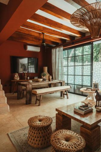 a living room with a bench and a table at The Lund Tulum in Tulum