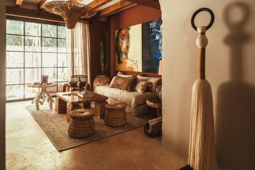 a living room with a couch and a table at The Lund Tulum in Tulum