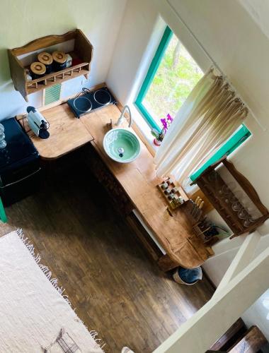an overhead view of a bathroom with a sink and a window at Inside, The Village- Atelier in Tunari