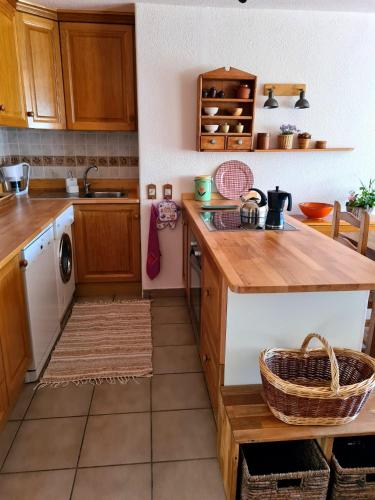 a kitchen with wooden cabinets and a counter top at Mirador del valle in Benimantell