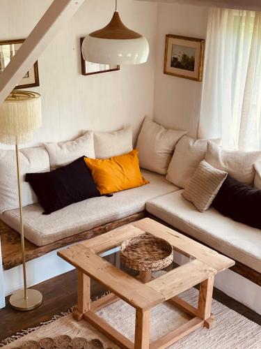 a living room with a couch and a coffee table at Inside, The Village- Atelier in Tunari