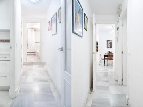 a hallway with white walls and a door at AlohaMundi Almansa in Seville