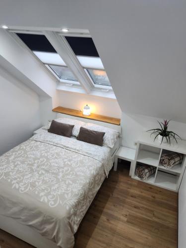 a attic bedroom with a bed and a skylight at Vila Rajska ptica in Bled