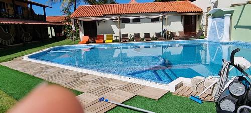 a swimming pool in the yard of a house at Pousada Portal do Maragogi in Maragogi