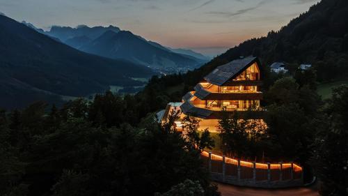 a house in the mountains with lights on at Chalet Sofija in Gozd Martuljek