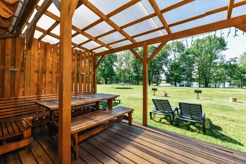 a wooden deck with a table and two chairs at Duriu sodyba in Molėtai
