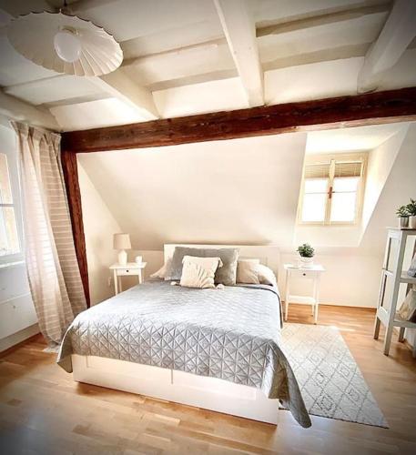 a bedroom with a bed and two tables and a ceiling at Dobré časy - Studio I. in Banská Štiavnica
