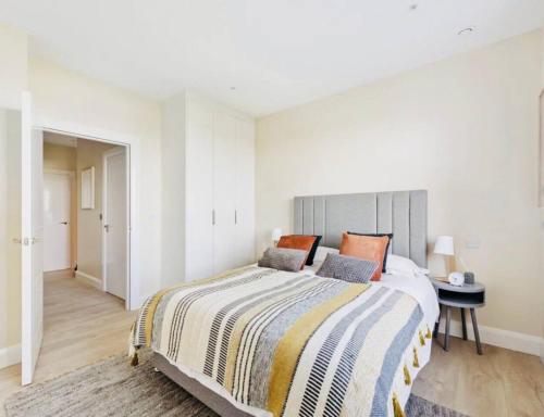 a bedroom with a large bed and a table at Luxury Seaview Apartment in Dublin