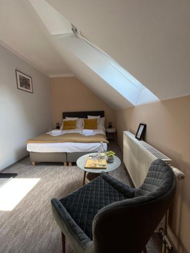 a bedroom with a bed and a couch and a table at Aventurin House *** in Révfülöp