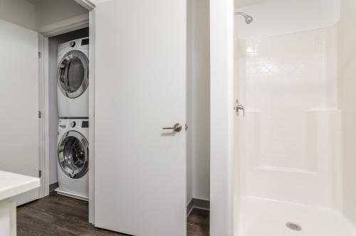 a white laundry room with a washer and dryer at LOFTSatJC next to BU and UHS Wilson and Lourdes in Johnson City