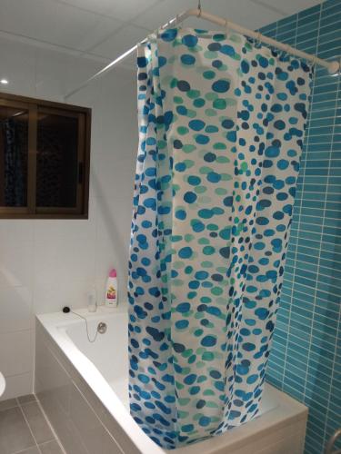 a blue and white shower curtain in a bathroom at Primera linea playa in Vinarós