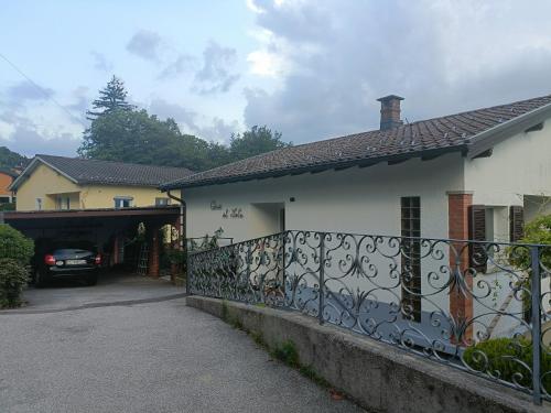 a house with a gate and a car parked in a driveway at Casa al Sole in Paradiso