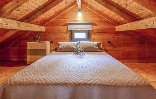 a bedroom with a large bed in a wooden cabin at Cabaña Lentisco in El Gastor
