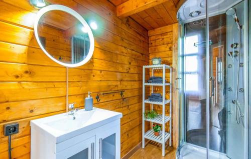 a bathroom with a shower and a sink and a mirror at Cabaña Lentisco in El Gastor