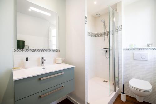 a bathroom with a sink and a toilet and a shower at Le Clos Eugénie in Gennes