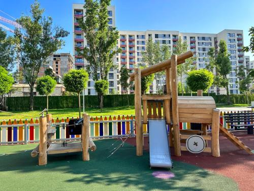 a playground with a slide in a park at Studio 21 in Bucharest