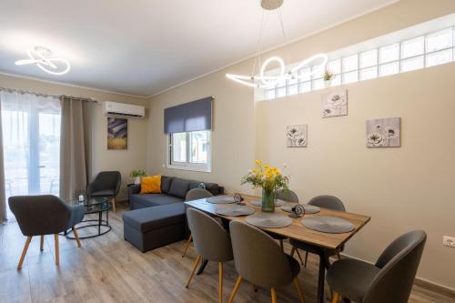 a living room with a table and a couch at Luxury & Cozy apartment in Messini