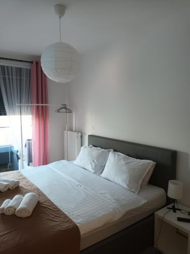 a bedroom with a bed with two white towels on it at Gajeva Rooms - Malmö apartment SELF CHECK-IN in Virovitica
