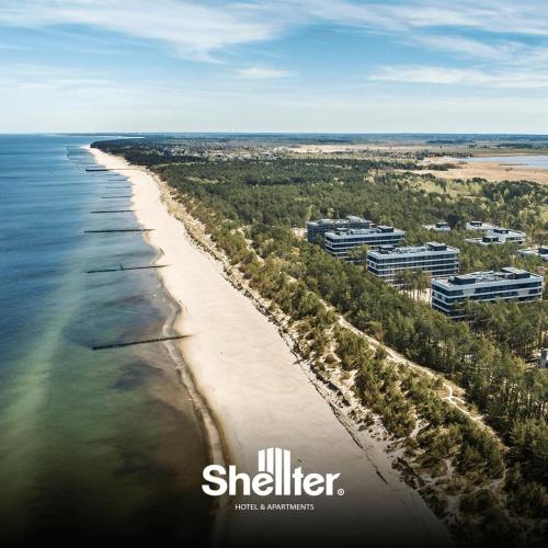 an aerial view of a beach with buildings and the ocean at Seaside Shellter Rogowo in Rogowo