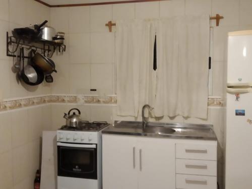 a small kitchen with a sink and a stove at La Solita in Mercedes