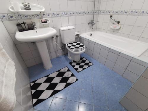 ein Badezimmer mit einem WC, einem Waschbecken und einer Badewanne in der Unterkunft Khan Property in Schardscha