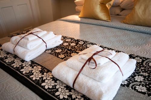 two towels on a tray on a bed at Hillside Lodge B&B in Clifden