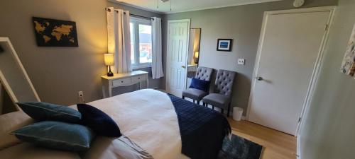 a bedroom with a large bed and a window at Lush's Lodge in Cormack
