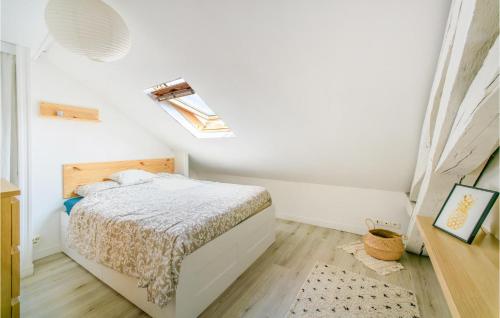 a white bedroom with a bed and a skylight at 3 Bedroom Lovely Apartment In Poitiers in Poitiers
