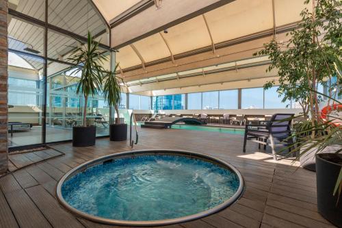 an indoor pool with a large tub in the middle of a building at Best Western Premier Marina Las Condes in Santiago