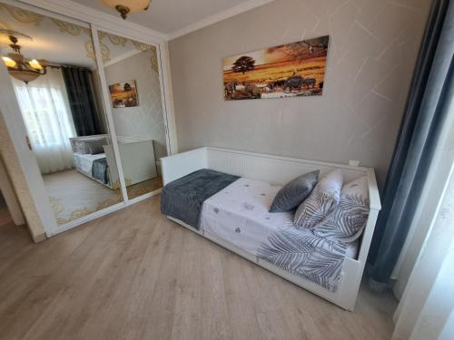 a small bedroom with a bed and a mirror at Rancho B 5 in Mijas Costa