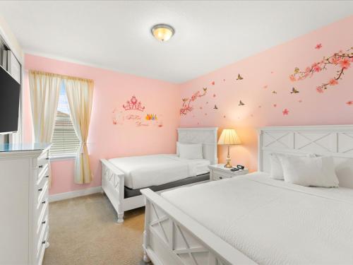 2 bedden in een slaapkamer met roze muren bij Modern Home With Private Pool Near Disney By Encore Resort At Reunion by Rentyl - 7738F in Orlando
